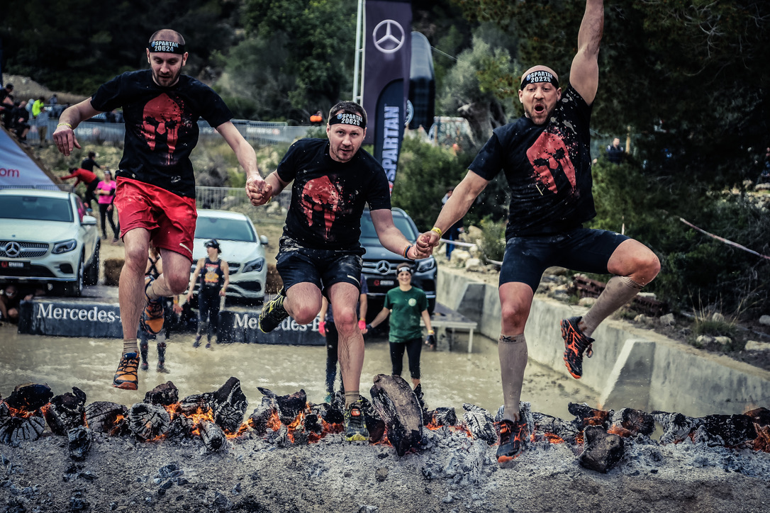 Finisher at the finish line after an obstacle course